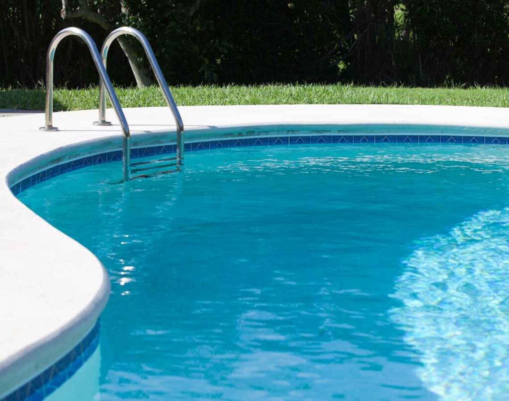 a swimming pool with a metal ladder