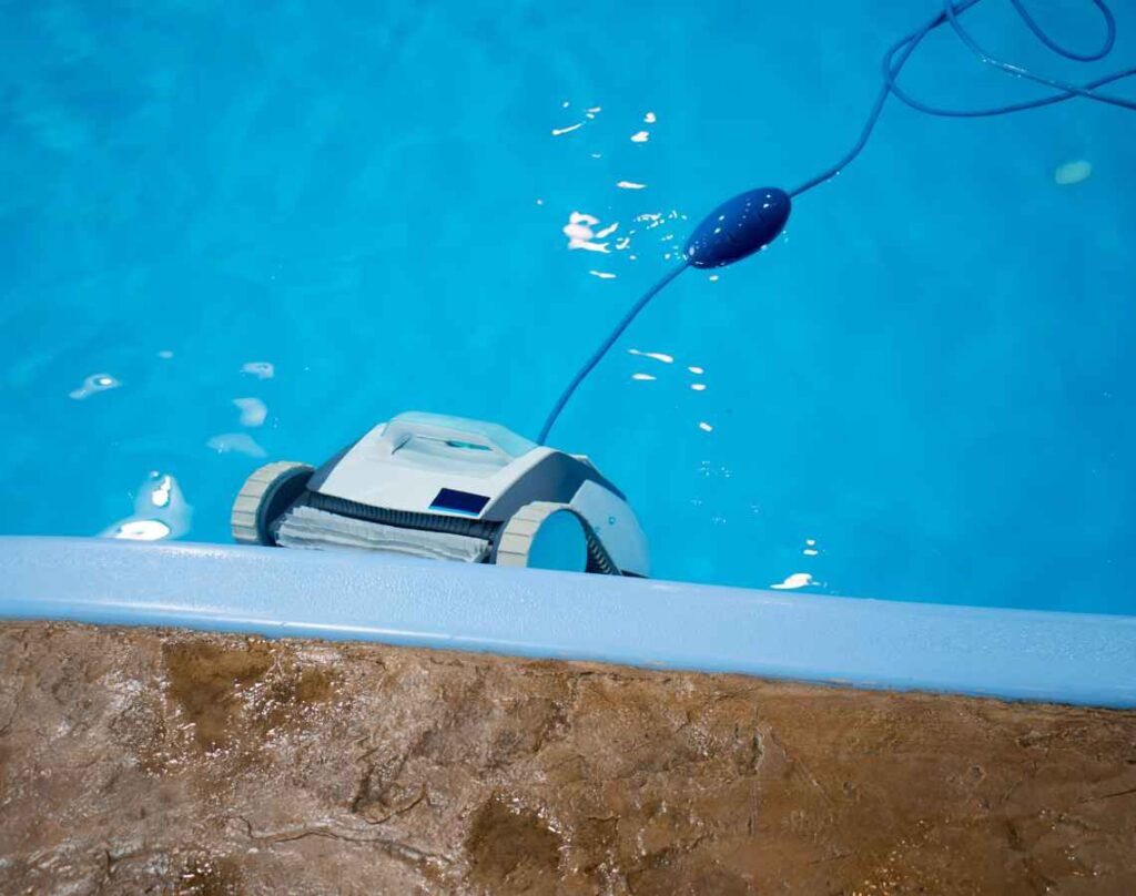 Pool cleaning robot on pool wall. Pool cleaning robots.