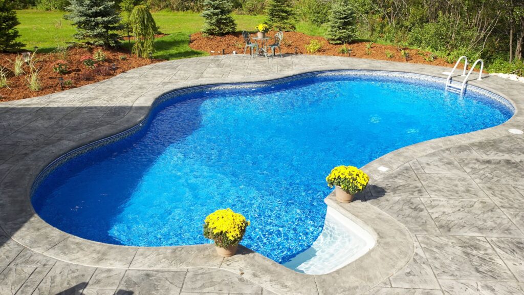 Outdoor pool surrounded by trees. How to Diagnose and Repair Your Pool Pump Like a Pro.