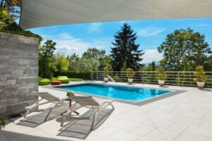 Modern poolside view with lounge chairs
